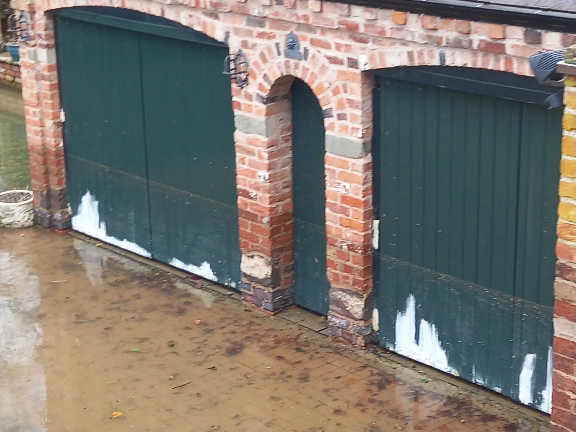 A high-water mark left across garage doors after floodwater receded
